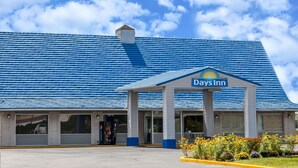 A Days Inn with a blue roof, large windows, and a sign above the entrance. - Days Inn by Wyndham Seymour (Seymour)