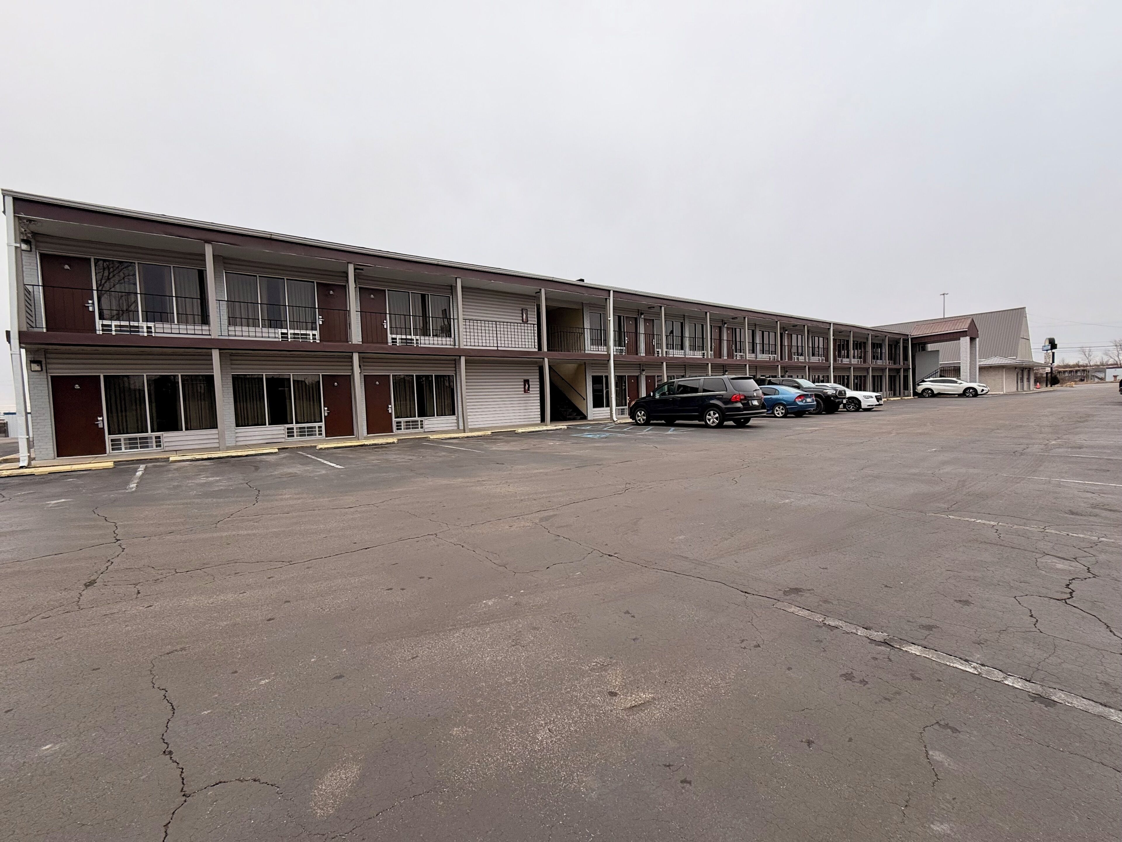A multi-story parking garage with several cars parked.