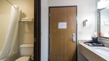 A bathroom with a shower, toilet, and sink.