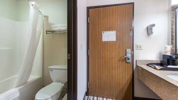 A bathroom with a shower, toilet, and sink.