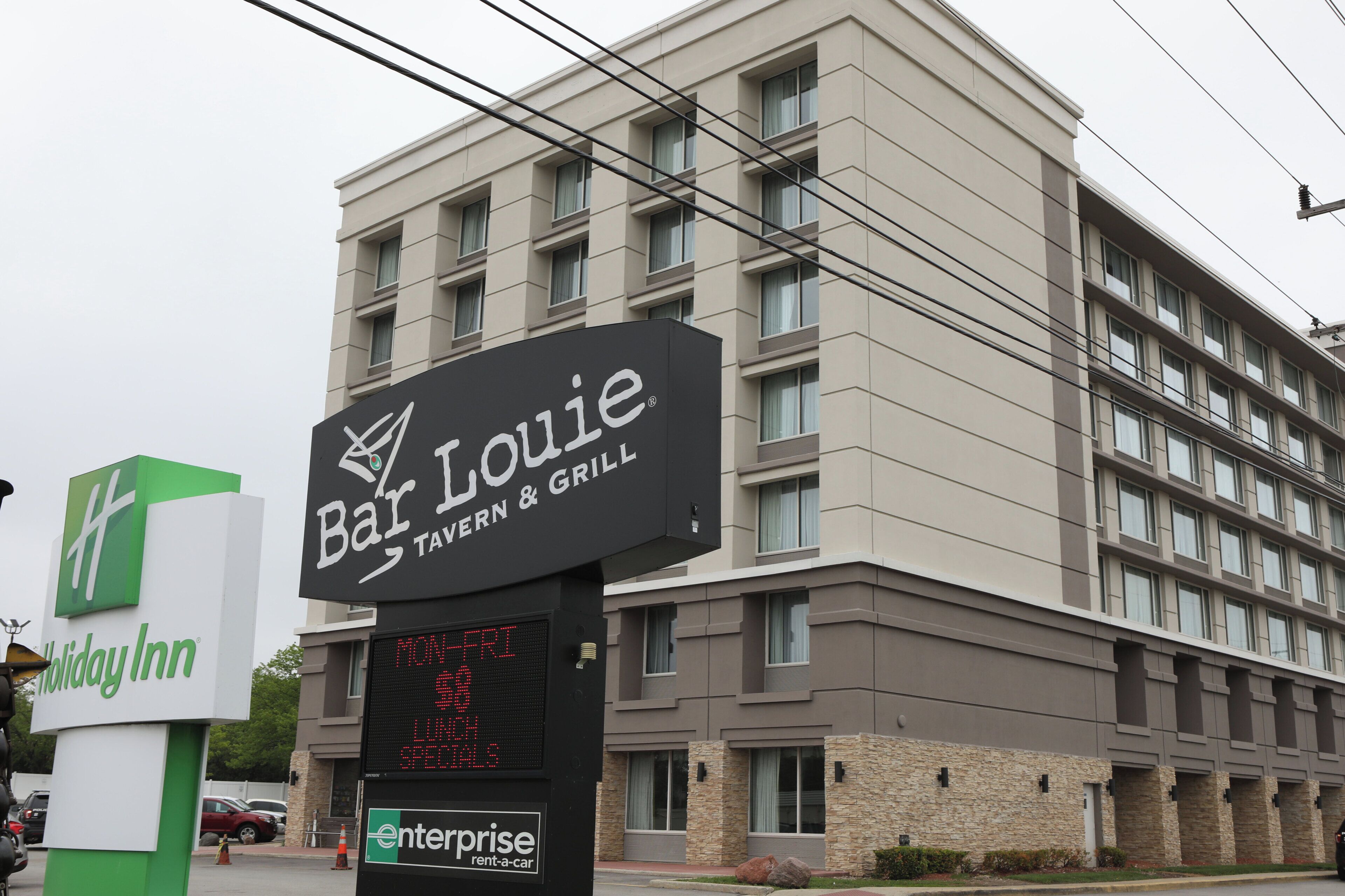 A multi-story building with a sign for Bar Louie, a tavern and grill.