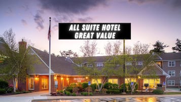 A hotel with a brick facade, a flagpole, and a sign indicating it is a Residence Inn.