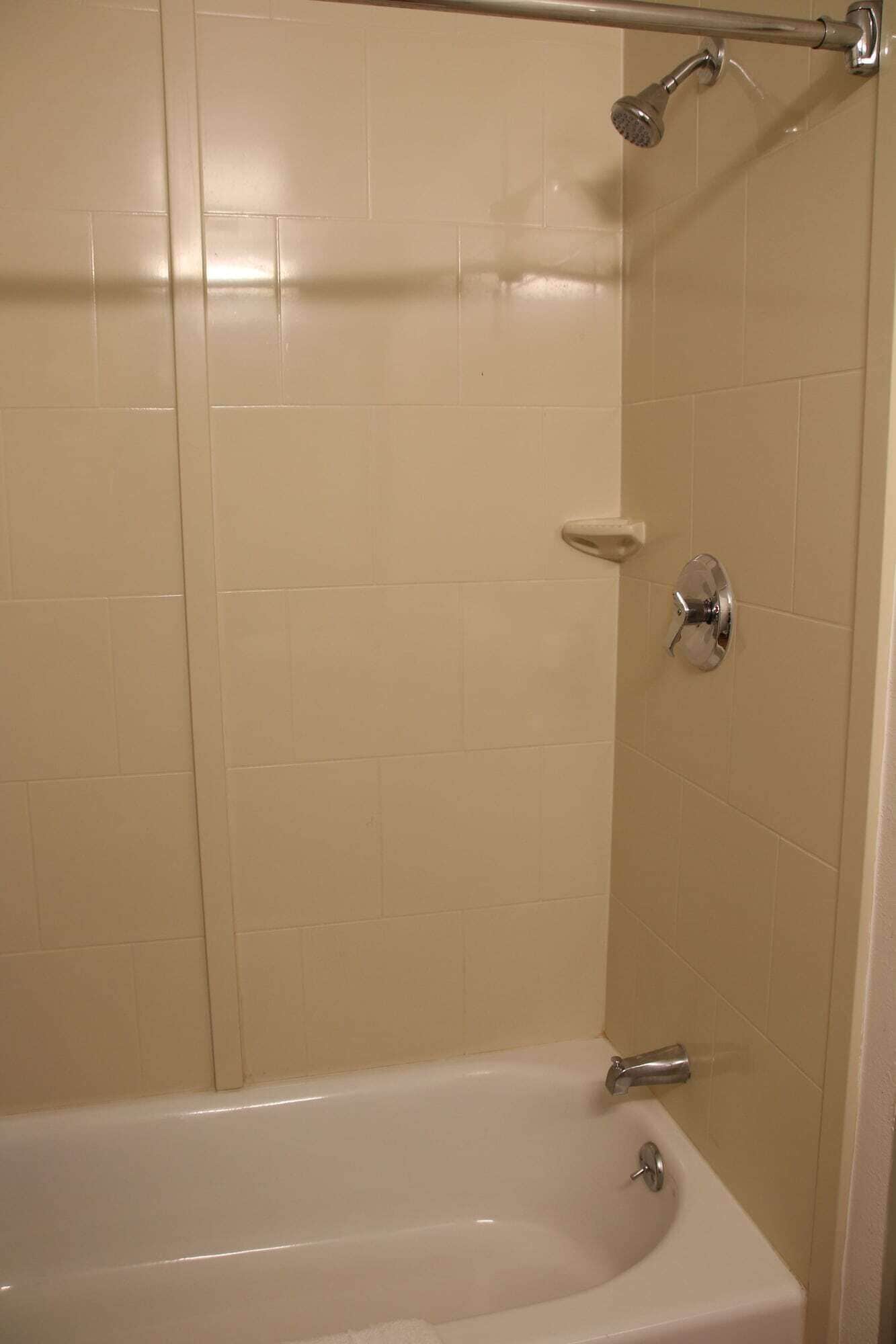 A bathroom with a bathtub, a shower, and a toilet.