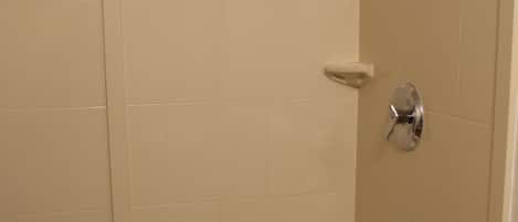 Un baño con bañera, ducha y dispensador de jabón.