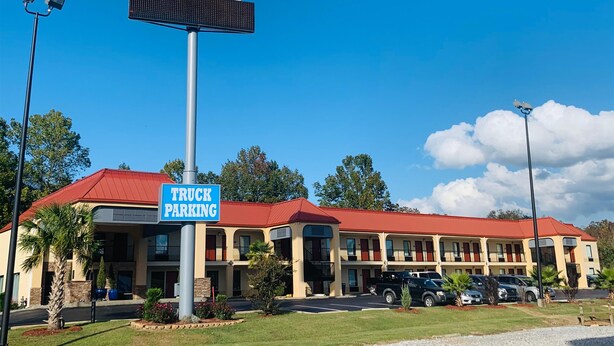 A SureStay hotel with a red roof, a truck parking sign, and a SureStay sign.