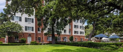 A multi-story building with a brick facade and large windows.