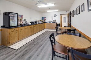 Enjoy a well-equipped kitchen with a refrigerator, microwave, coffee machine, and sink, perfect for preparing meals.