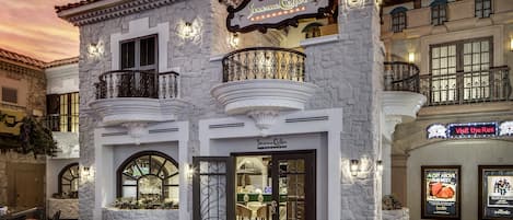 A steakhouse with a stone facade, wrought iron balconies, and a sign reading "Sonoma Cellar Steakhouse".