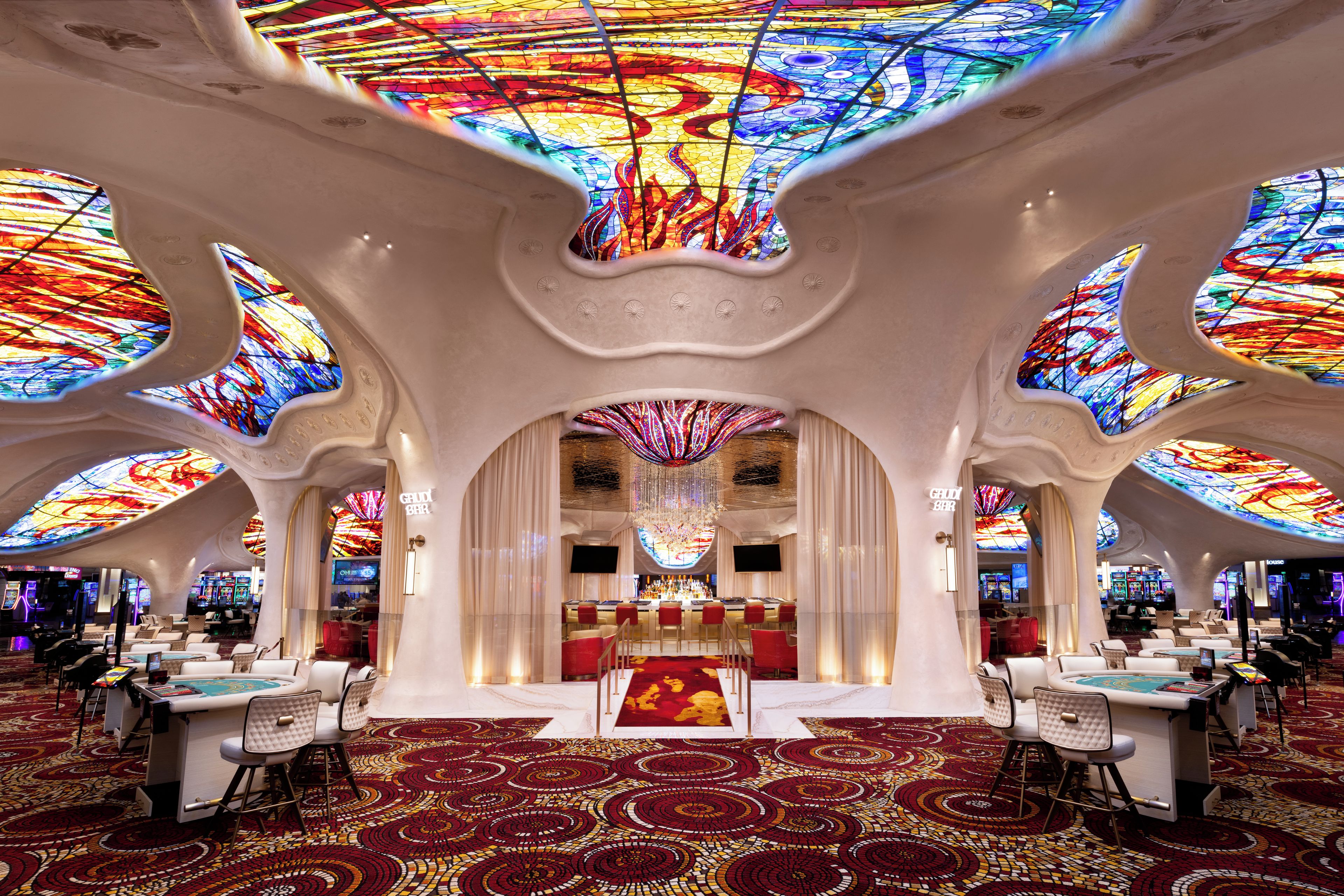 A luxurious interior with a bar area, seating, and a distinctive ceiling design.