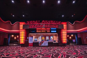 Regal Cinemas Luxury Seating with IMAX screens, a digital marquee, and a carpeted floor.