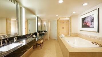 A modern bathroom with a large mirror, two sinks, a bathtub, and a shower area.