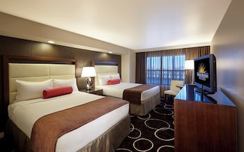 Deluxe Room, 2 Queen Beds | Pillowtop beds, laptop workspace, blackout drapes, iron/ironing board at Sunset Station Hotel & Casino