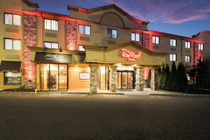 A hotel with a prominent Red Roof Inn sign, a brick facade, and a welcoming entrance. - Red Roof Inn Fairfield (Fairfield)