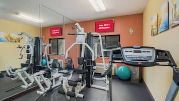 A gym with cardio equipment, weight machines, and a treadmill.