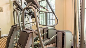 A gym with treadmills, a stair climber, and a weight machine. - Quality Inn near Mountain Creek (Vernon)