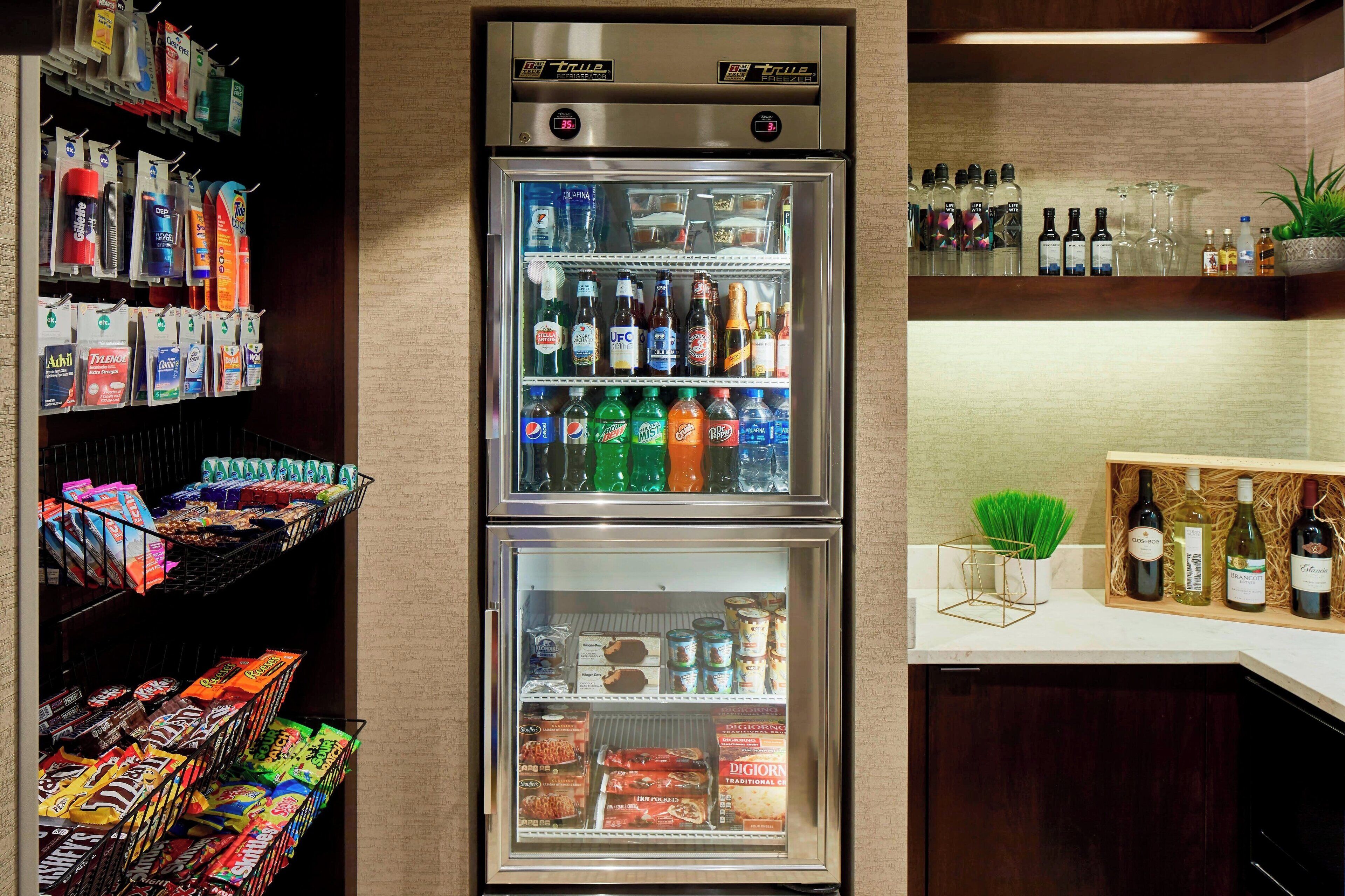 A minibar with snacks, beverages, and a wine cooler.