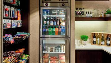 A minibar with snacks, beverages, and a wine cooler.