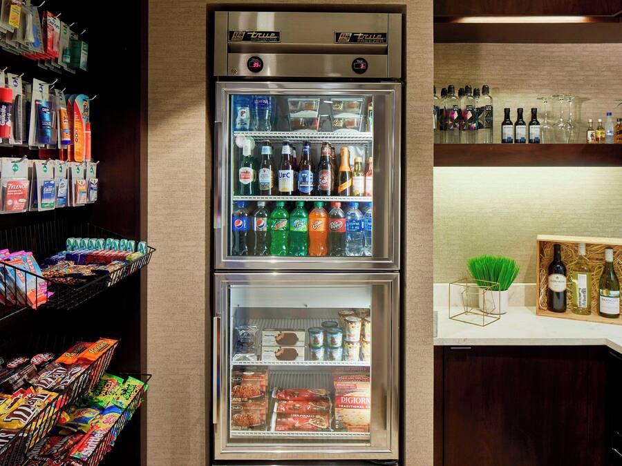A minibar with snacks, beverages, and a wine cooler.