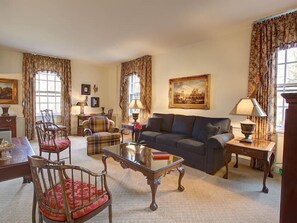 A traditional living room with a sofa, chairs, a coffee table, and a painting on the wall. - Geneva On The Lake (Geneva)