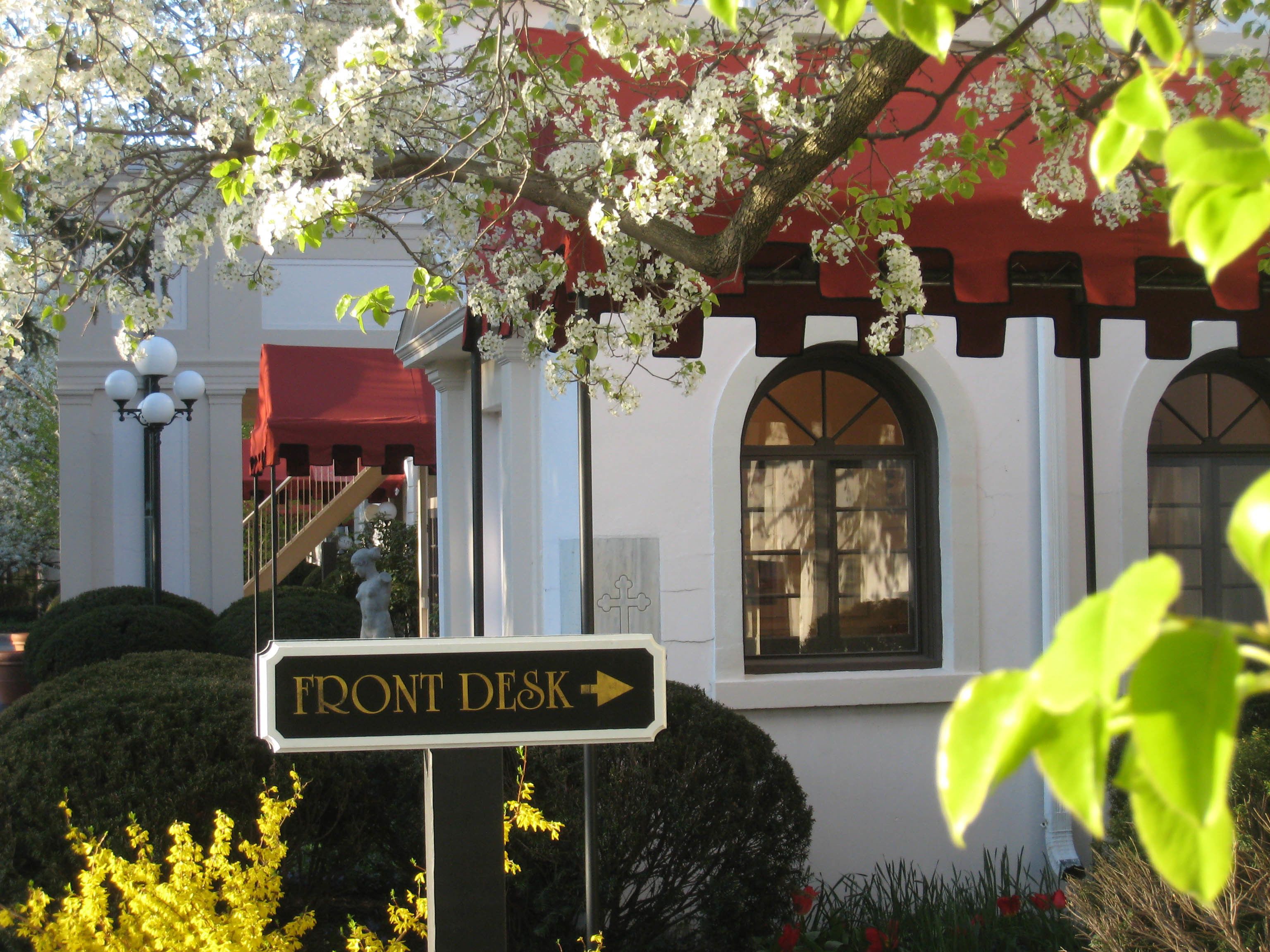 A building with a sign indicating a front desk.