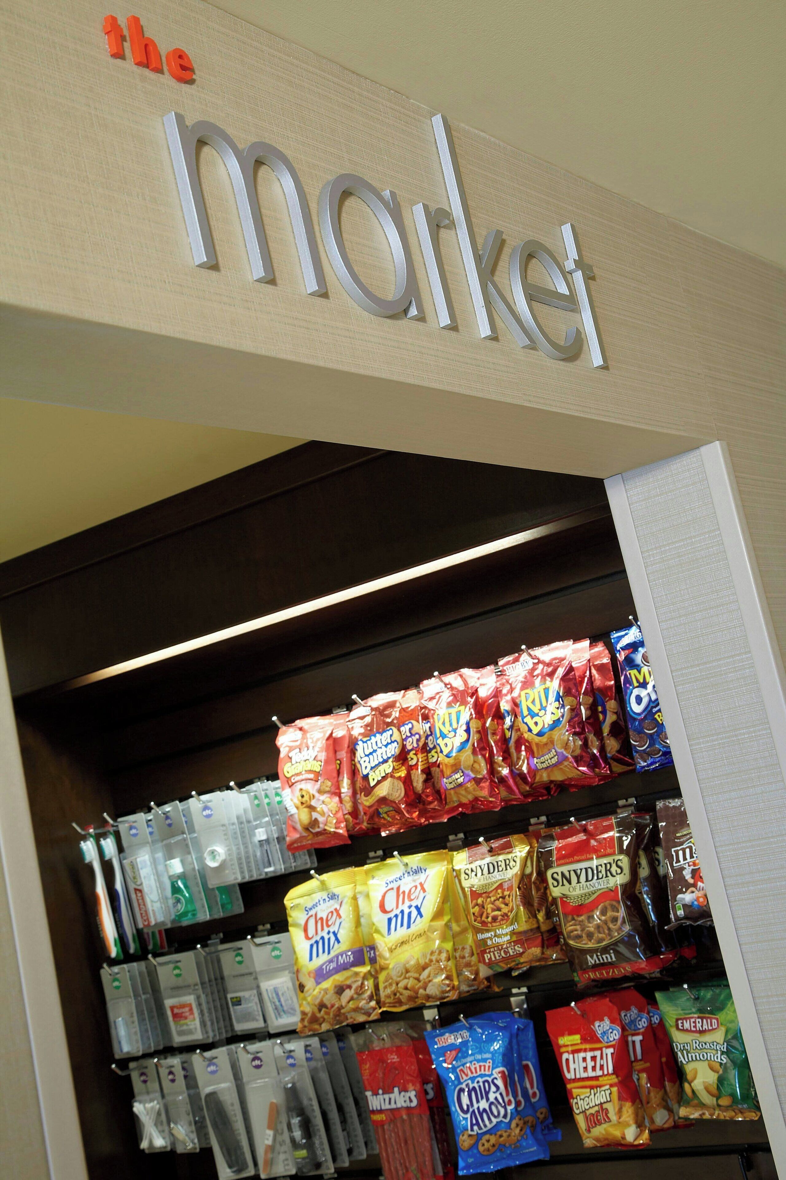 A snack display in a store with various chips and snacks.