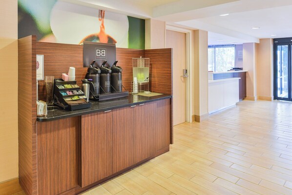 A reception desk with a coffee machine, a water dispenser, and a digital scale.
