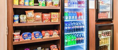 A refrigerated display case stocked with various beverages and snacks.