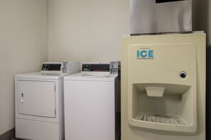 A laundry area with two front-loading washers and a built-in ice dispenser. - Red Roof Inn Weedsport (Weedsport)