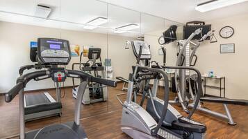 A gym with various cardio machines, including treadmills and elliptical trainers.