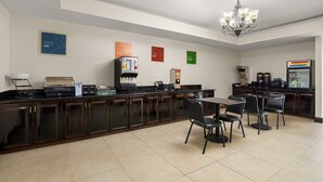 A hotel kitchen with a coffee station, a refrigerator, and a microwave. - Red Roof Inn Washington, NC (Washington)