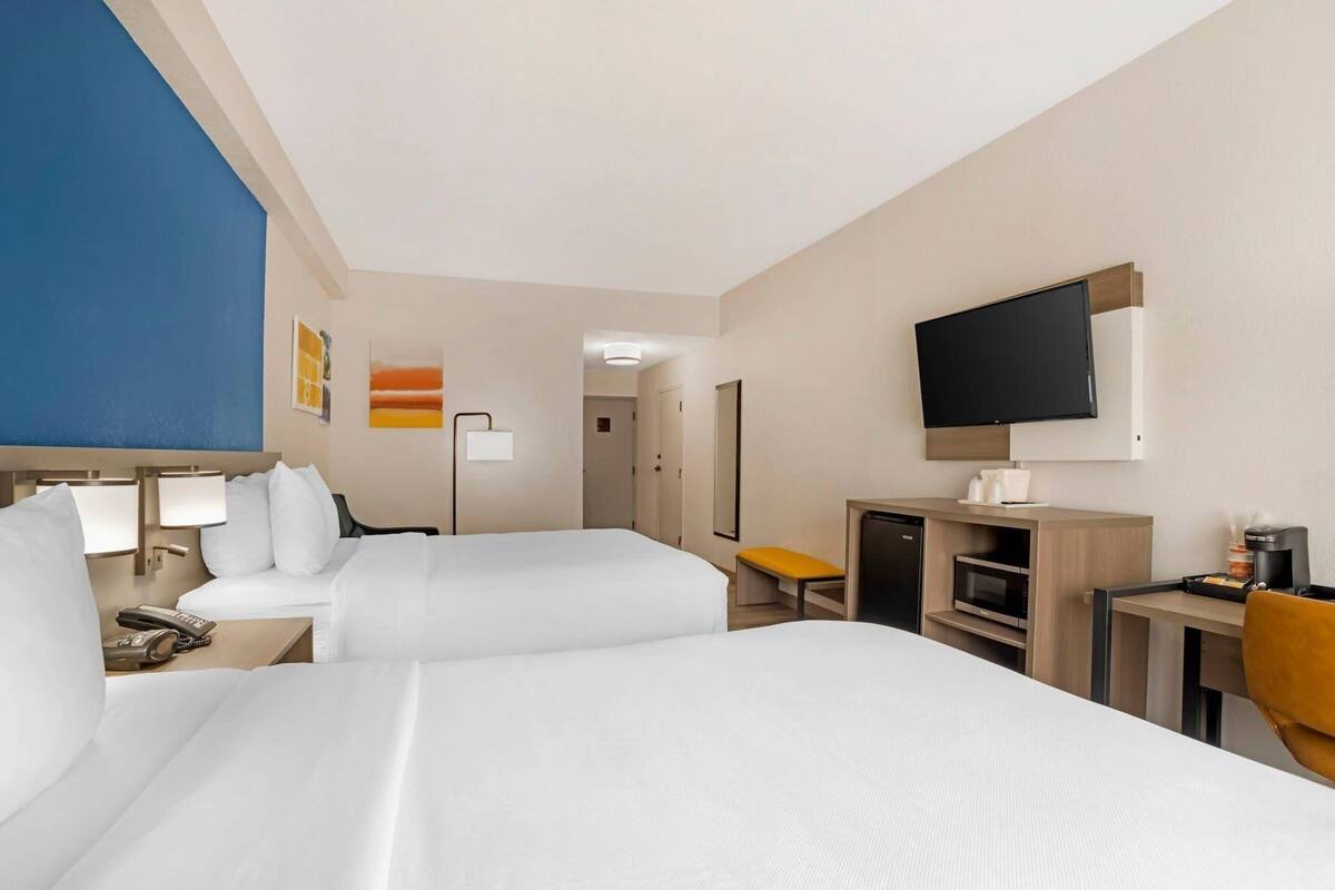 Premium bedding, desk, laptop workspace, blackout curtains