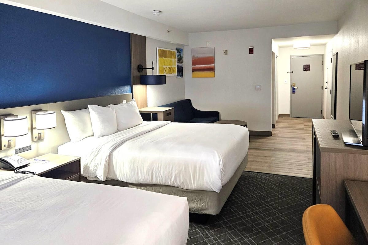 Premium bedding, desk, laptop workspace, blackout curtains