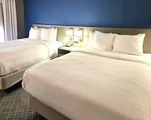 Premium bedding, desk, laptop workspace, blackout curtains