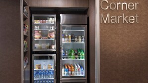 A corner market with refrigerated display cases containing various food items and beverages. - Fairfield Inn by Marriott Charlotte Gastonia (Gastonia)