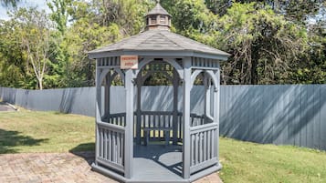 A gazebo with a sign indicating a smoking area.