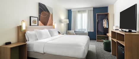 Ropa de cama de alta calidad y caja de seguridad en la habitación