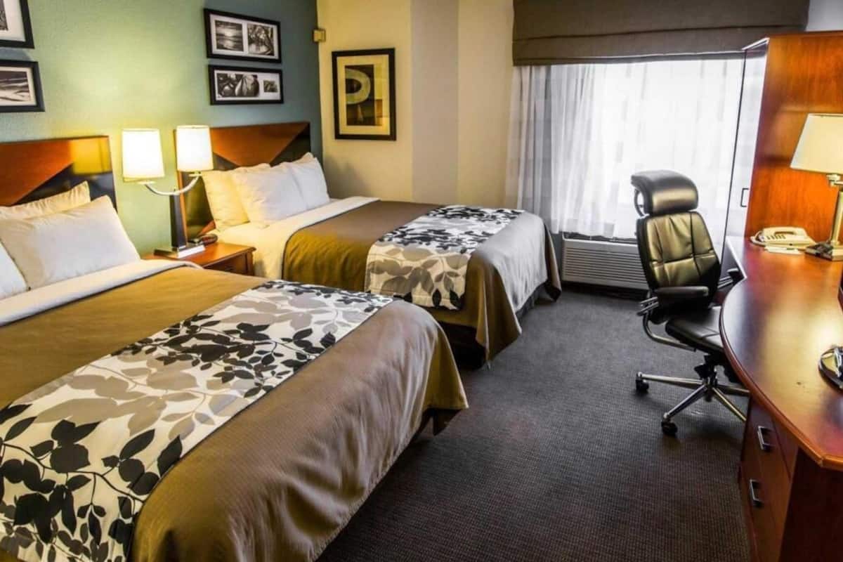 Premium bedding, desk, laptop workspace, blackout drapes