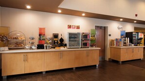 A buffet area with various food stations, including a refrigerated display, a hot food station, and a fresh food station.