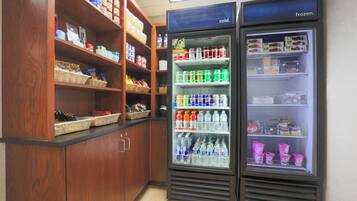 A refrigerated display case with various beverages and snacks.