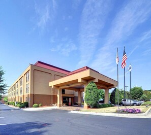 A hotel with a red roof, American flags, and a covered entrance. - Hampton Inn Eden (Eden)