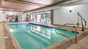 An indoor swimming pool with clear water, a tiled floor, and a lifeguard station. - Comfort Inn Oxford - University Area (Oxford)
