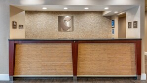 A reception desk with a logo, a service animal sign, and a green check-in sign. - Comfort Inn Oxford - University Area (Oxford)