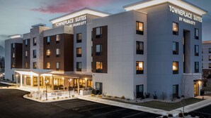 A modern hotel with 'Towneplace Suites by Marriott' signage, featuring a spacious entrance with outdoor seating and a well-lit facade. - TownePlace Suites by Marriott Sidney (Sidney)