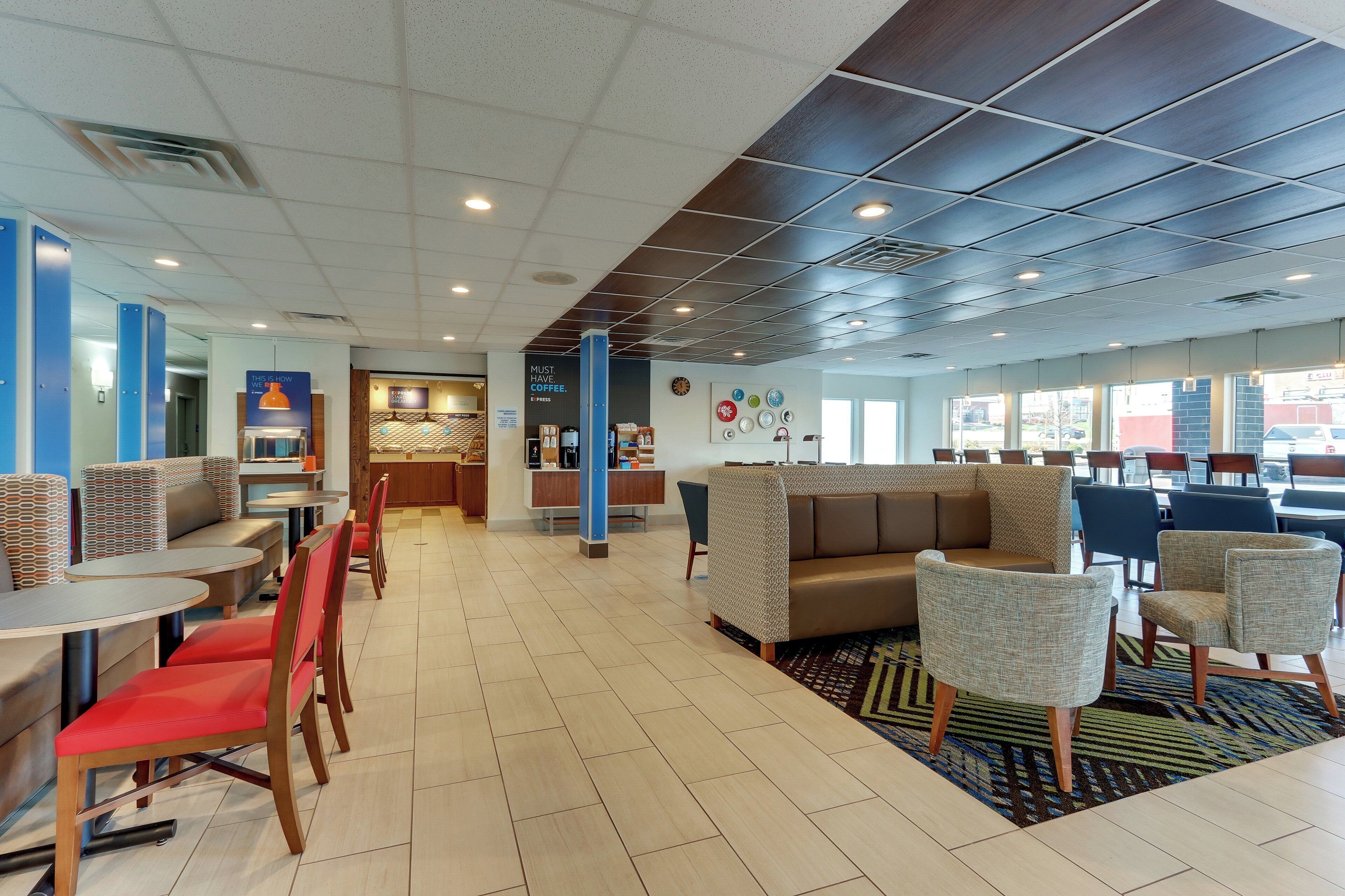 A modern cafe interior with seating arrangements, a coffee bar, and a view through the windows.
