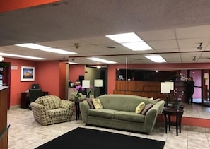 Welcome to our lobby, where guests can relax on a comfortable sofa and armchair, and enjoy a warm atmosphere.