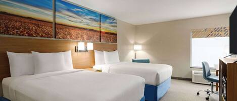 A hotel room with two beds, a desk, and a large painting on the wall.