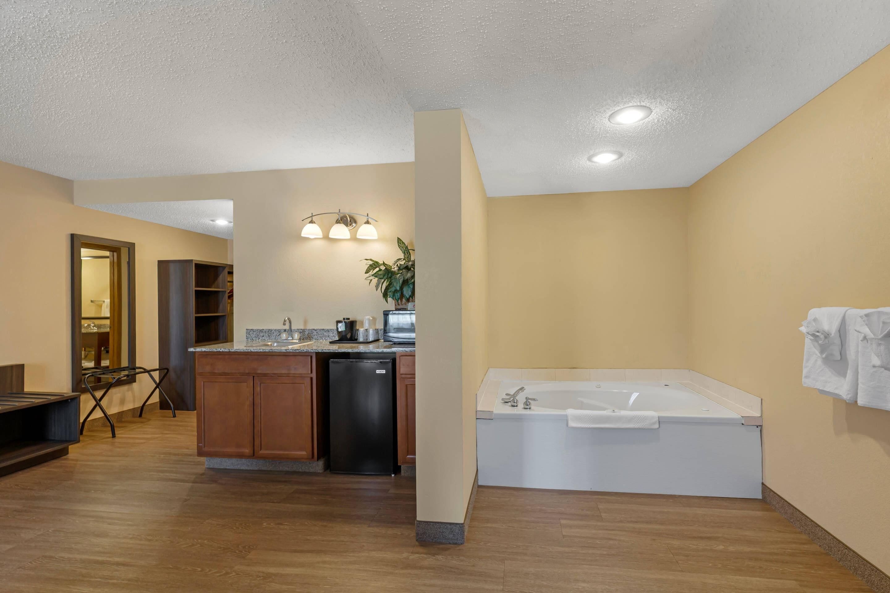 A modern bathroom with a bathtub, a sink, and a toilet.