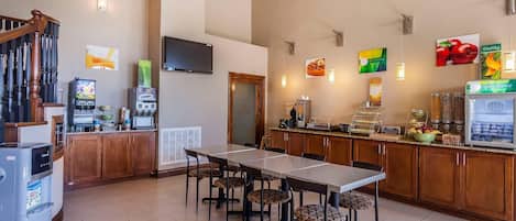 A modern kitchen with a dining area, wooden cabinets, and a built-in refrigerator.