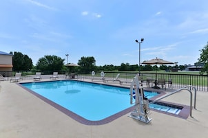 Una piscina al aire libre de temporada, sillones reclinables de piscina