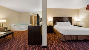 A hotel room with a bed, bedside table, lamp, and a large window. - Best Western Hermiston Inn (Hermiston)
